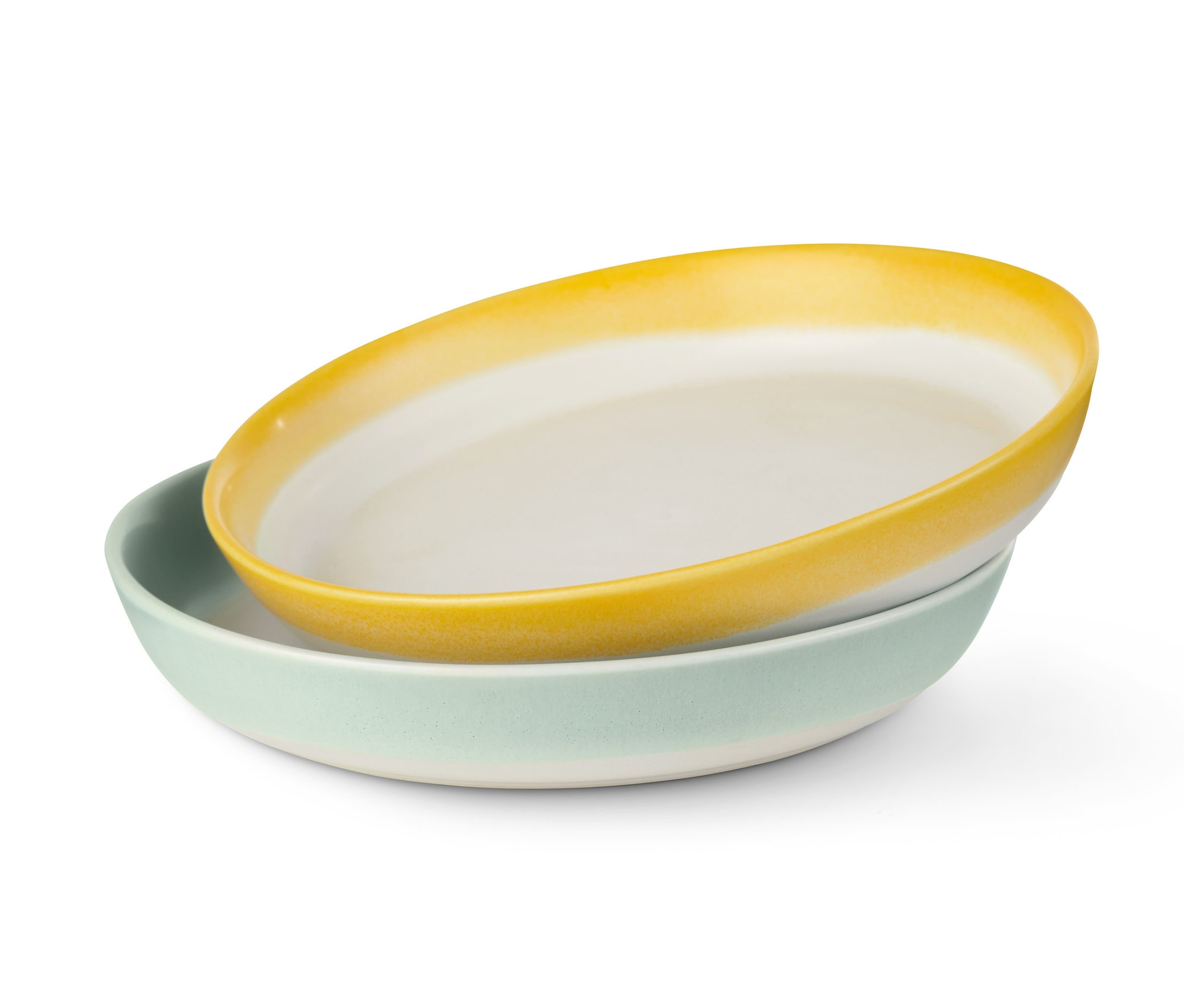 Dwa talerze, jeden żółty i jeden jasnozielony, leżą na sobie.