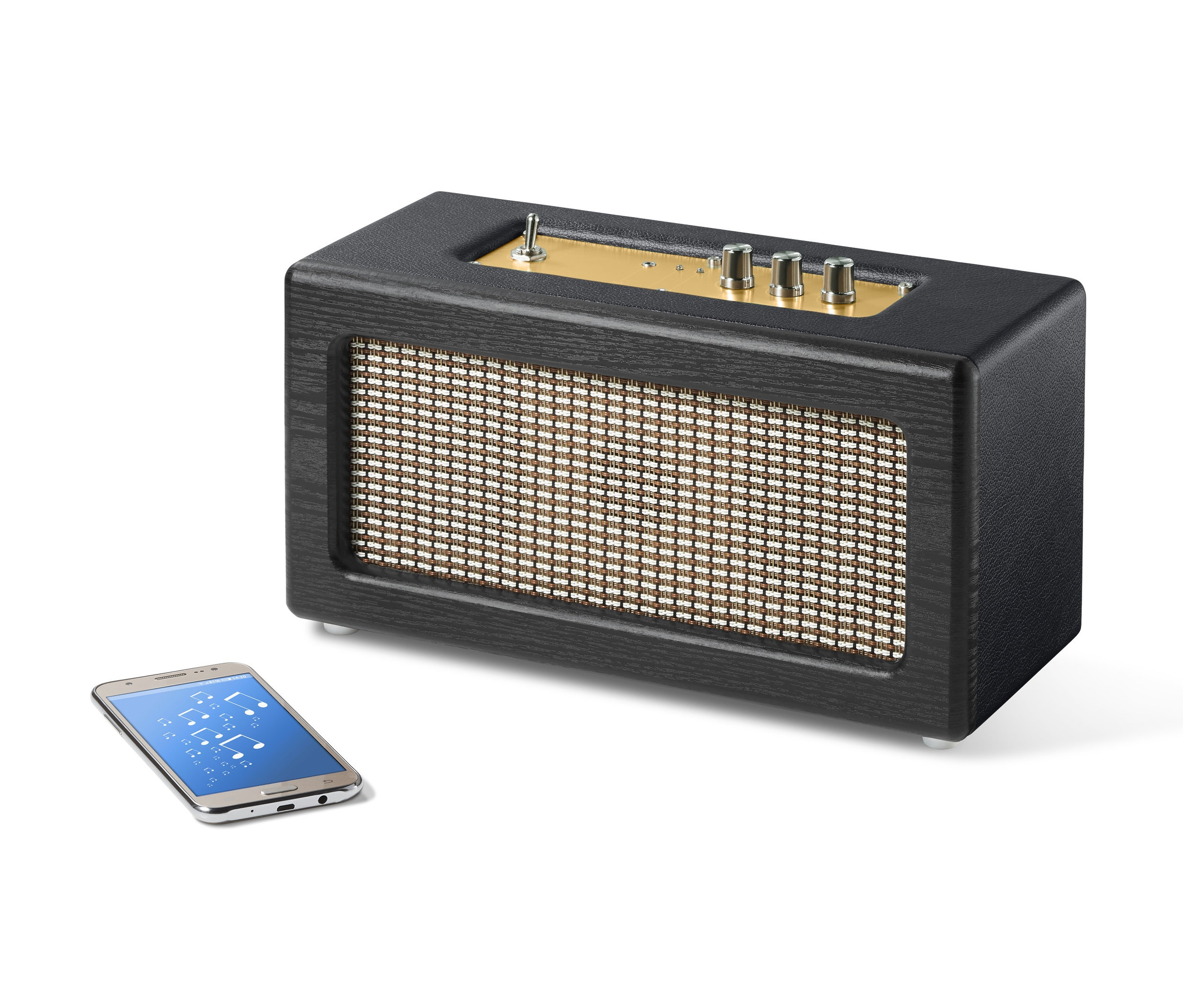 Czarny głośnik Bluetooth® w stylu retro obok smartfona.