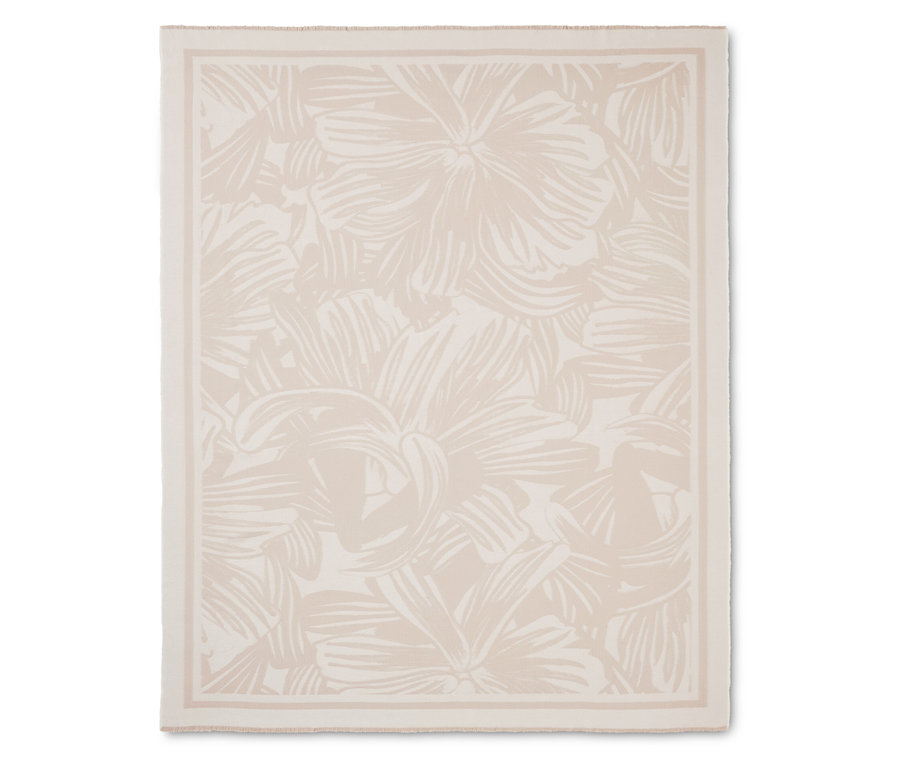 Kremowy koc w kwiatowy wzór z obramowaniem.