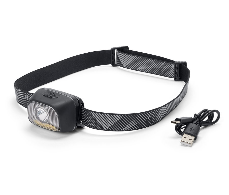 Czarna latarka czołowa z szaro-białym wzorzystym paskiem i kablem do ładowania USB.