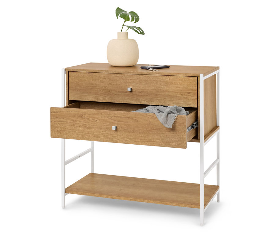 Komoda z dwiema szufladami, z których górna jest zamknięta, a dolna lekko otwarta, na górze wazon z rośliną, telefon i klucz.