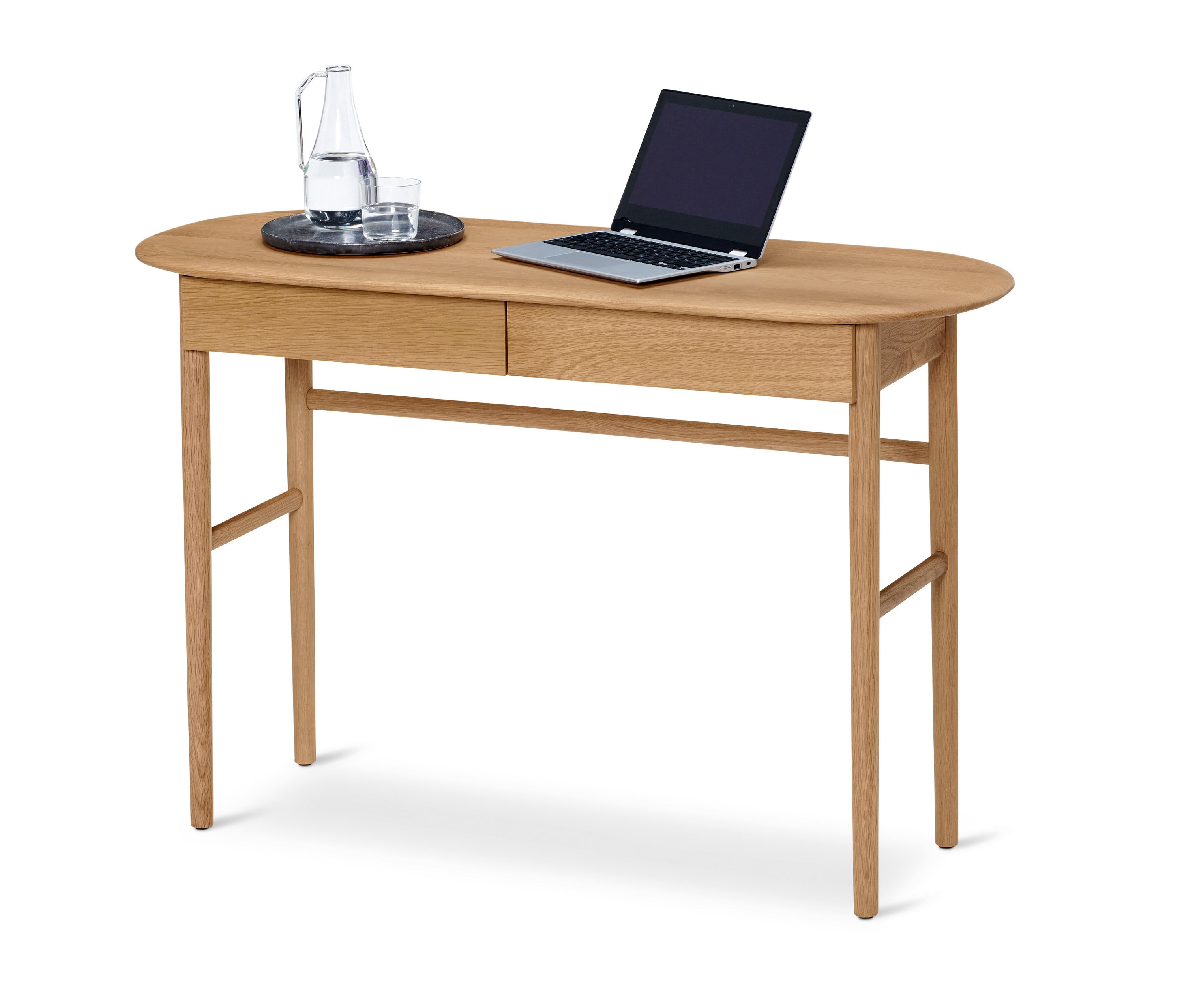 Na stole stoi sekretarzyk z szufladami, na którym znajduje się laptop, karafka z wodą i szklanka.