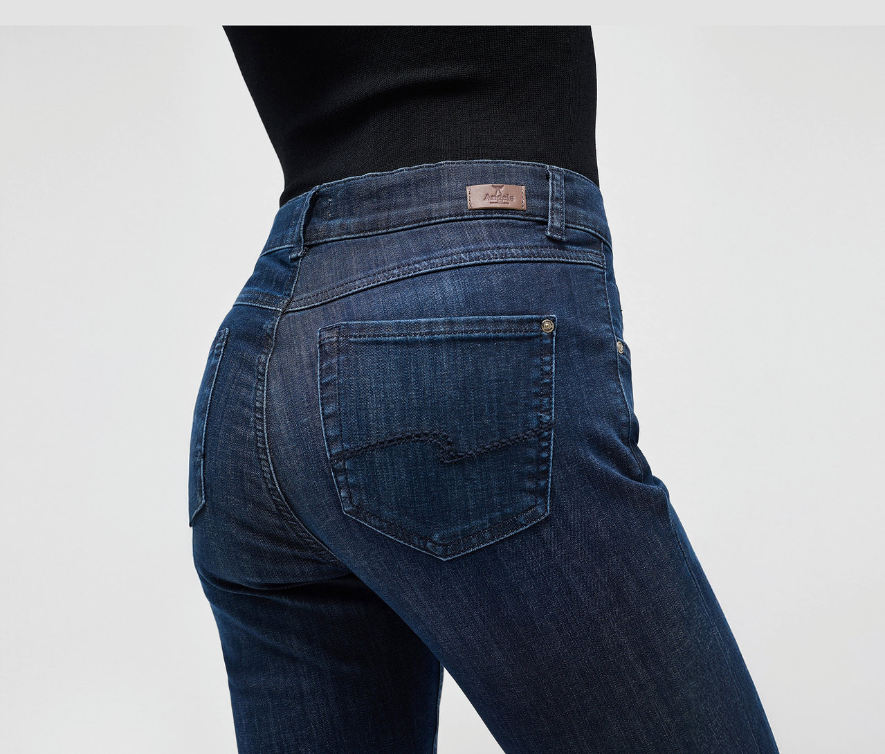 Zbliżenie na osobę ubraną w granatowe dżinsy Angels „Cici” Slim Fit.