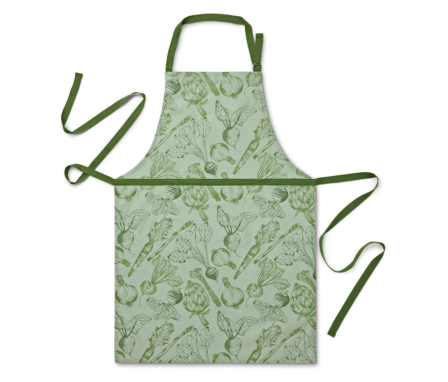 Fartuch z nadrukiem warzyw na jasnozielonym tle.