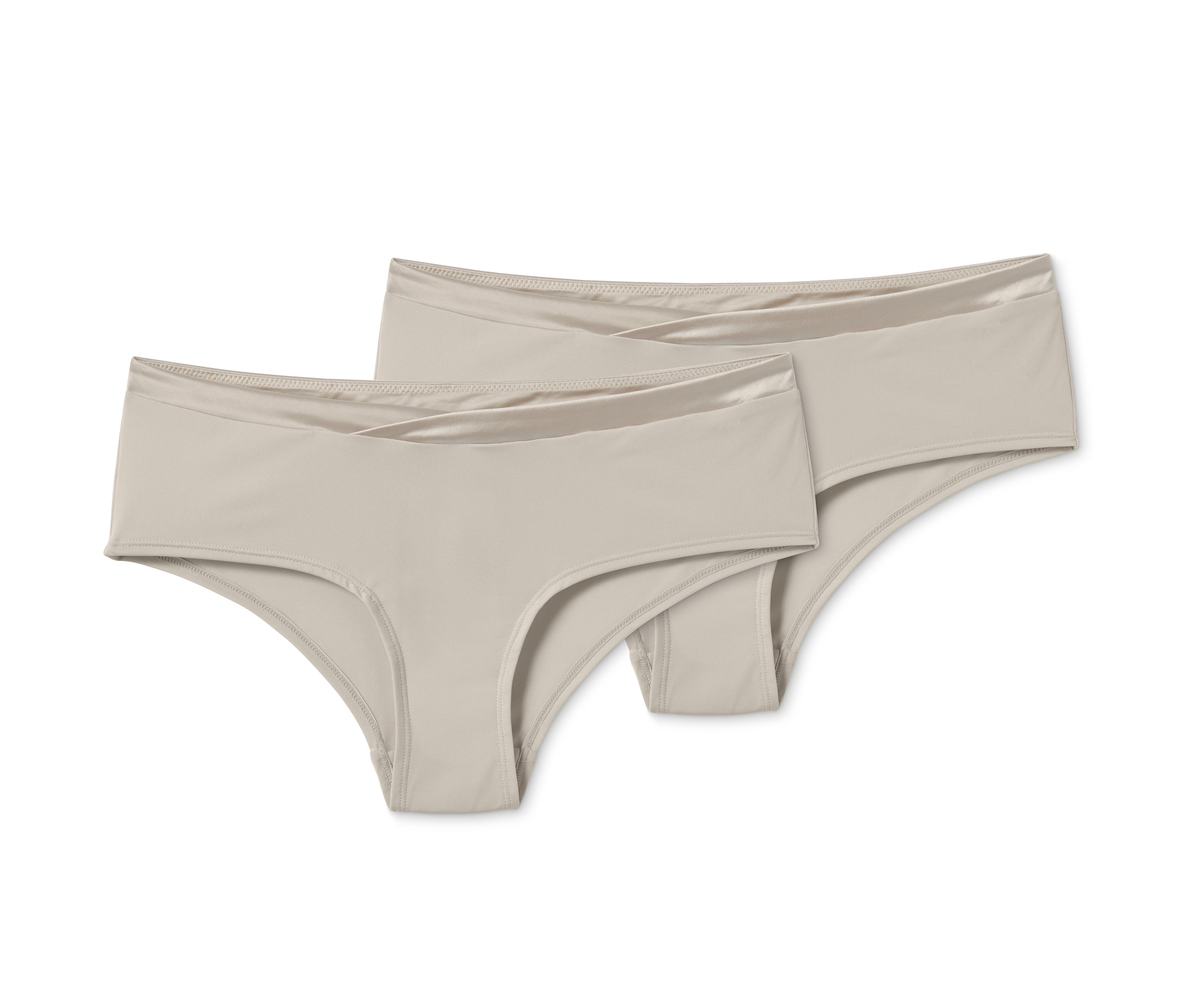 Dwie pary majtek biodrówek w kolorze beżowym.