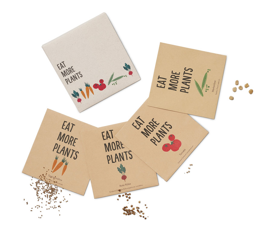 Rozłożony zestaw do wysiewu warzyw »dawne odmiany« z napisem „Jedz więcej roślin”.