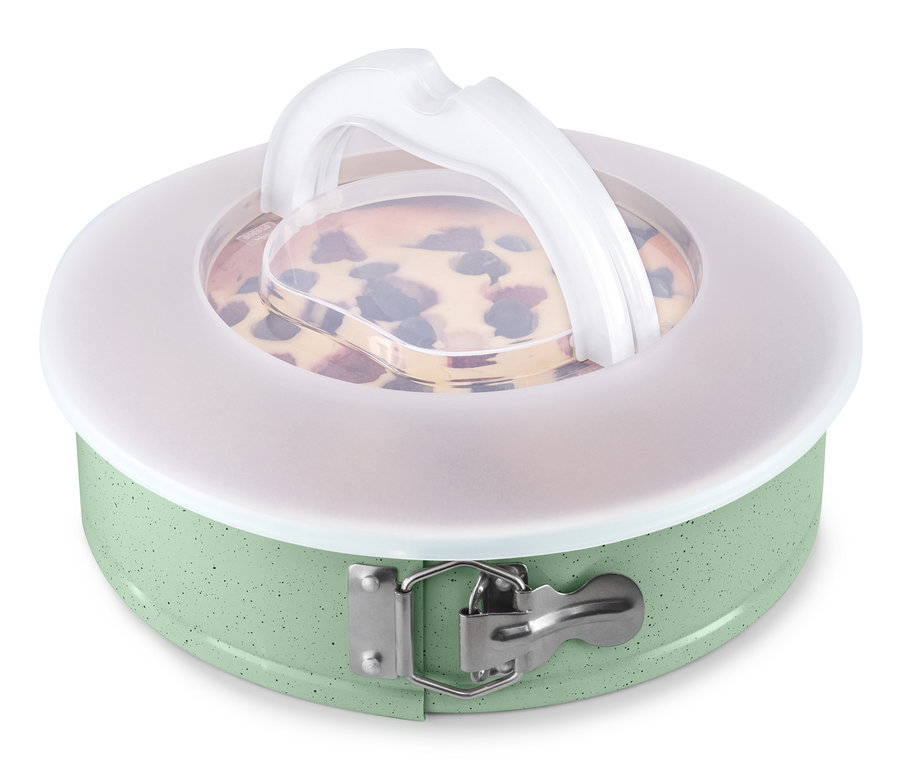 Zielona forma do pieczenia z pokrywką do transportu i upieczonym ciastem.