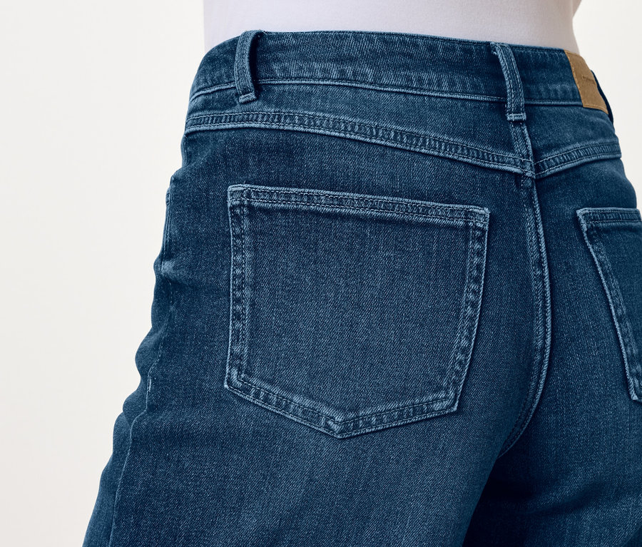 Szczegół tylnej części niebieskich jeansów z kieszeniami.