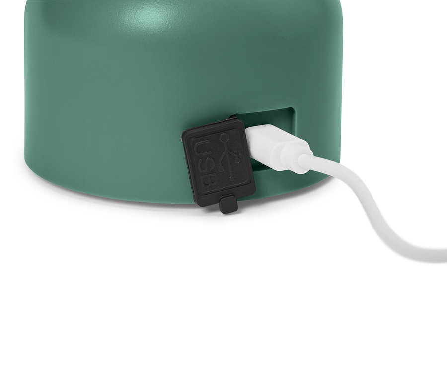 Zbliżenie miętowo-zielonego urządzenia z podłączonym kablem USB.
