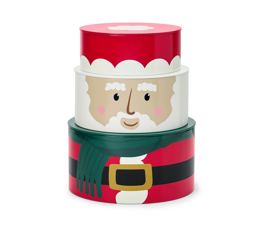 Zestaw trzech puszek na ciastka z motywem świątecznym, ułożonych jedna na drugiej.