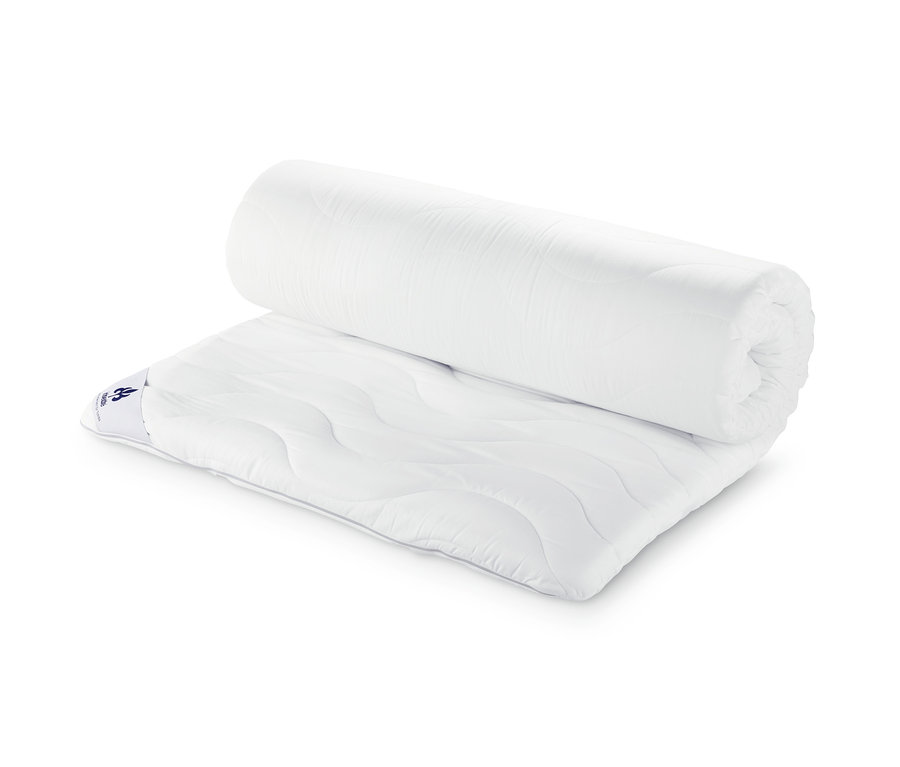 Częściowo zwinięta nakładka na materac irisette® greenline, ok. 140 x 200 cm.