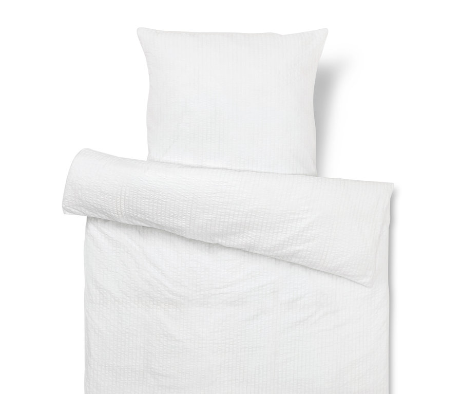 Biała poszewka na poduszkę i kołdrę z teksturą.