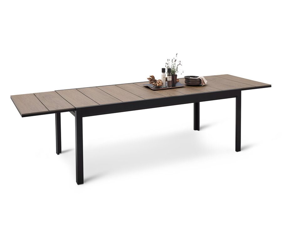 Długi stół jadalny z czarną ramą i drewnianym blatem, na którym znajduje się taca z dekoracjami.