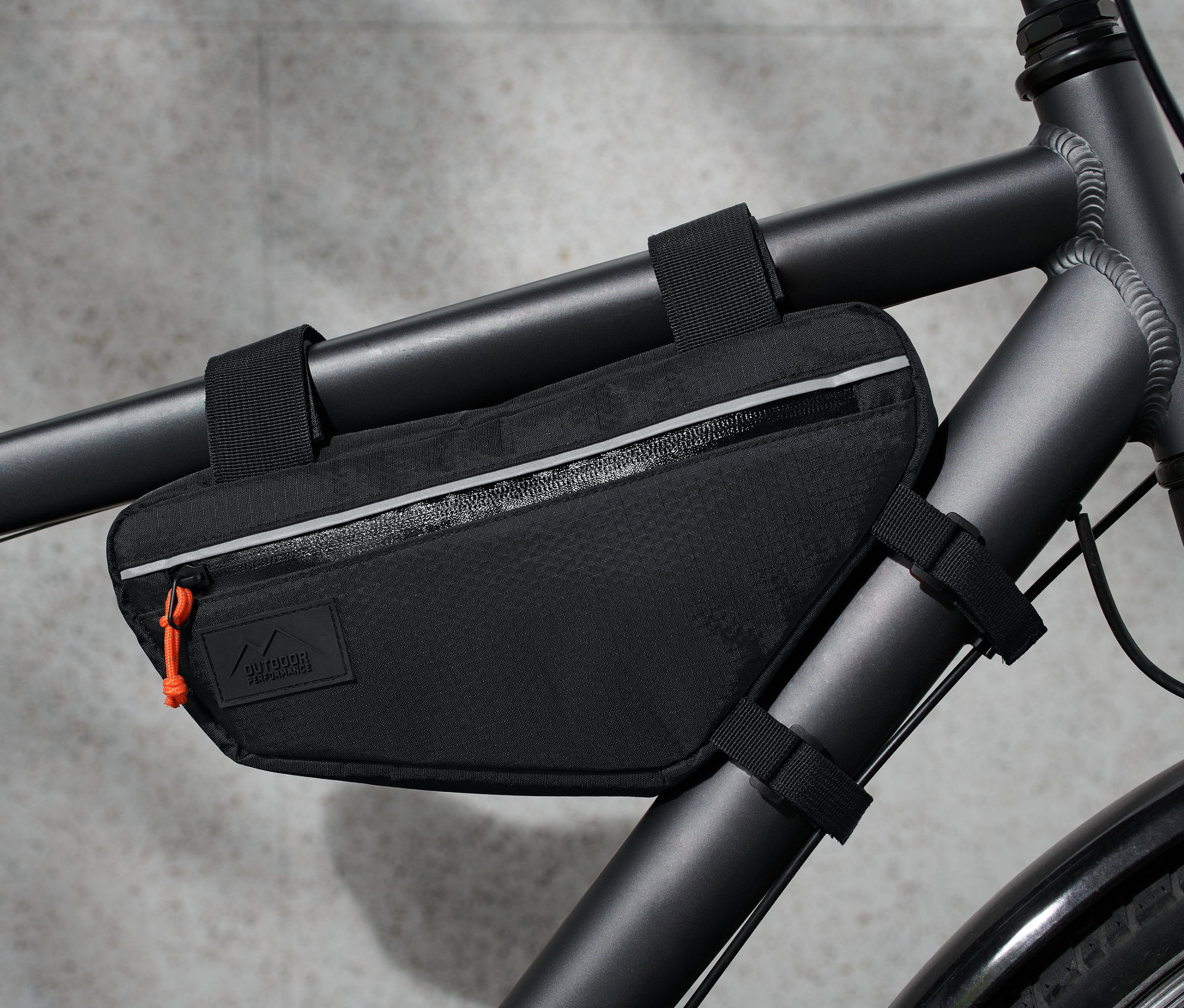 Czarna torba na ramę rowerową przymocowana do ramy roweru.