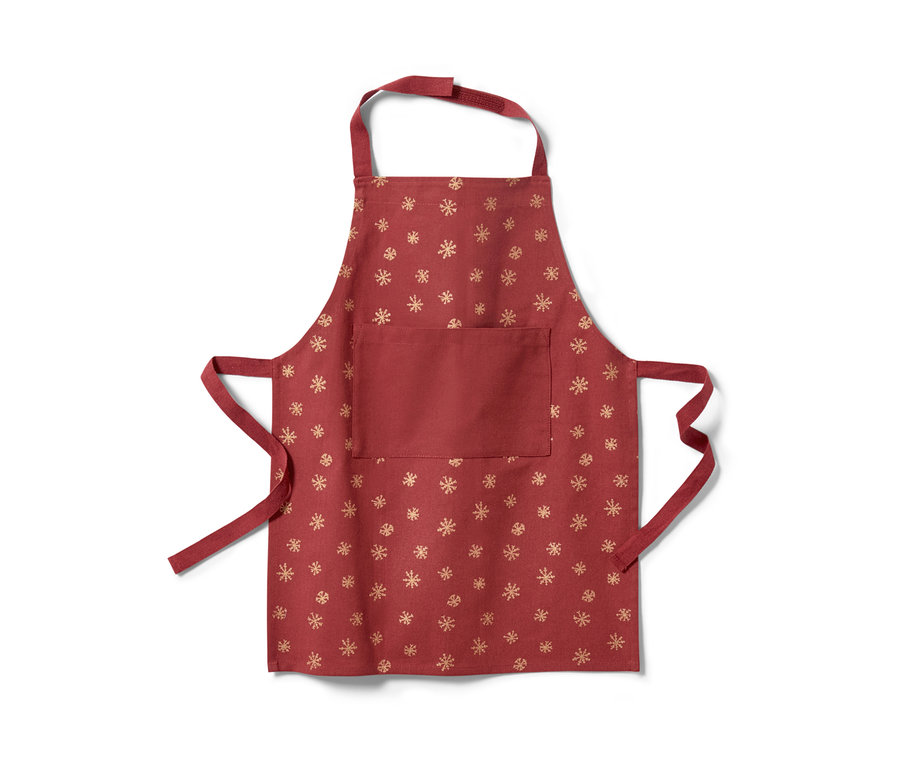 Czerwony fartuch dziecięcy ze złotym wzorem płatków śniegu.