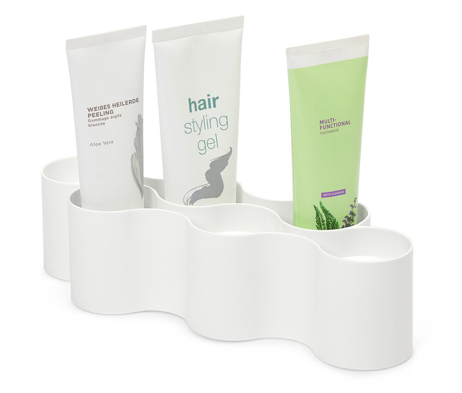 Trzy tubki kosmetyków w białym plastikowym pojemniku.