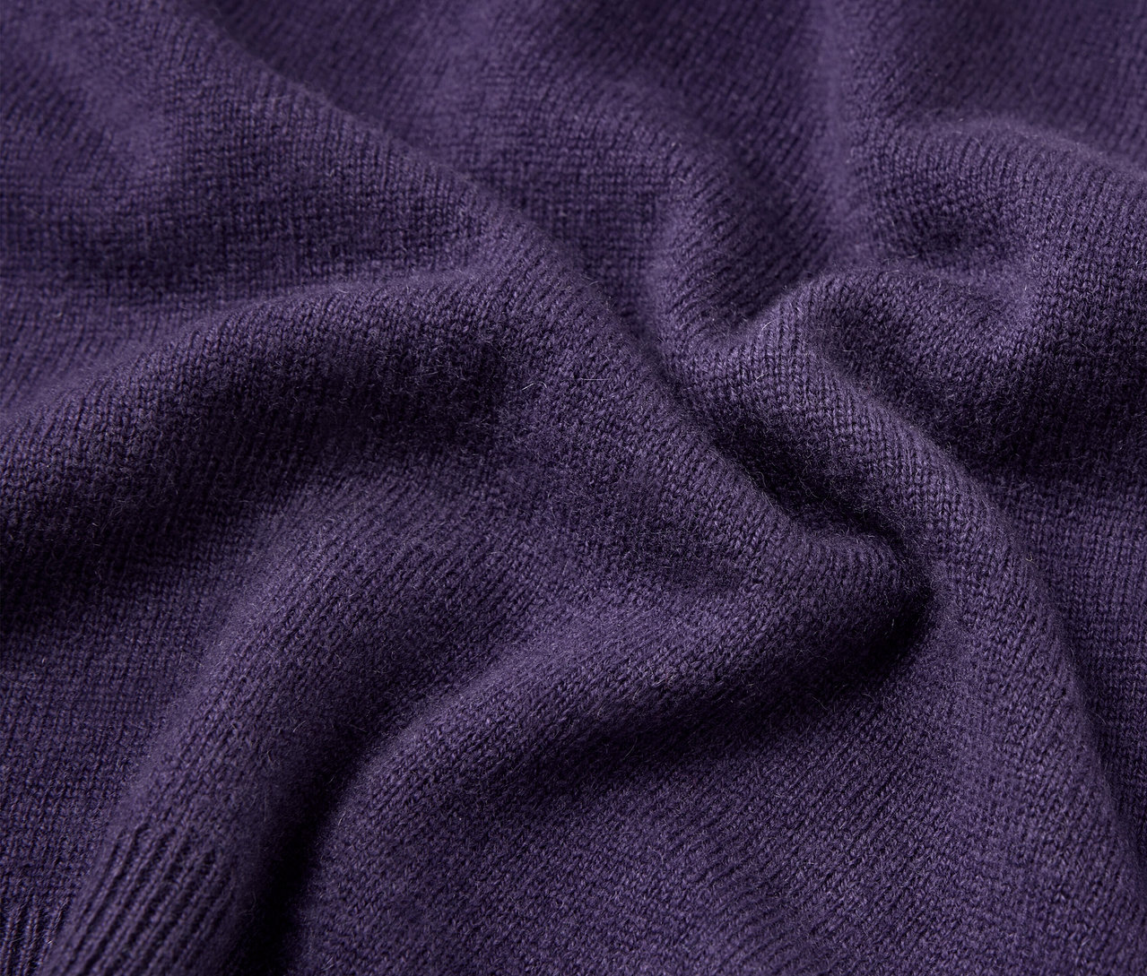 Zbliżenie na teksturę fioletowego swetra.