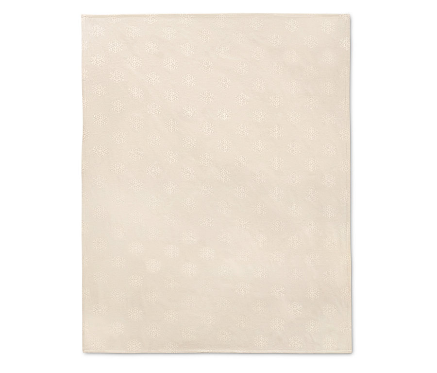 Kremowy obrus żakardowy we wzór płatków śniegu.