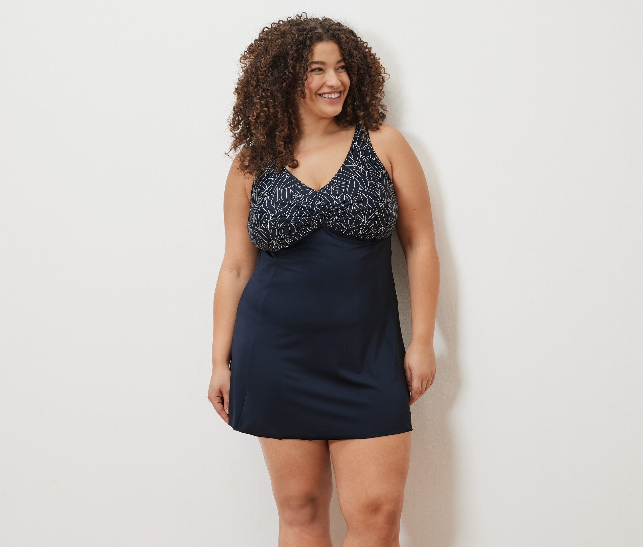 Uśmiechnięta kobieta w sukience kąpielowej.