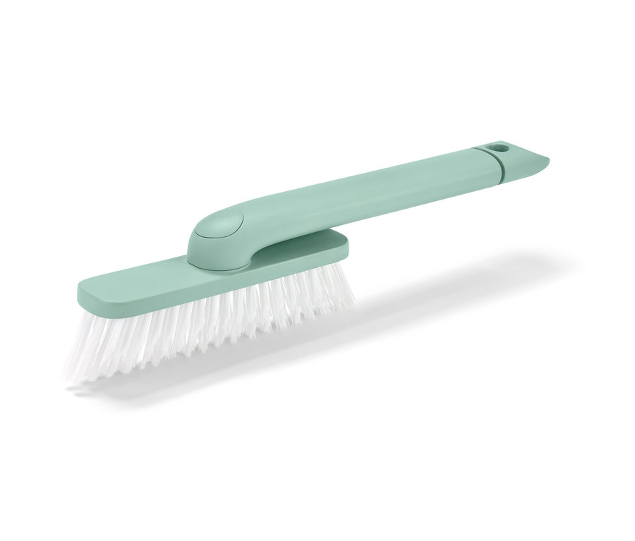 Zielona szczotka do fug 4 w 1 z białym włosiem na białym tle.