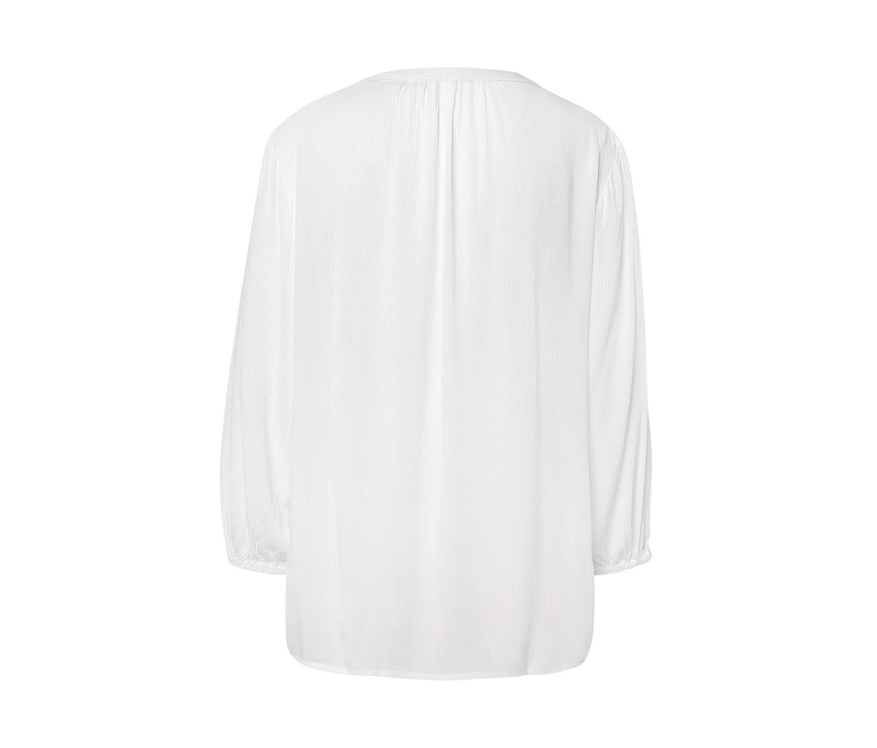 Szczegół białej bluzki-tuniki.