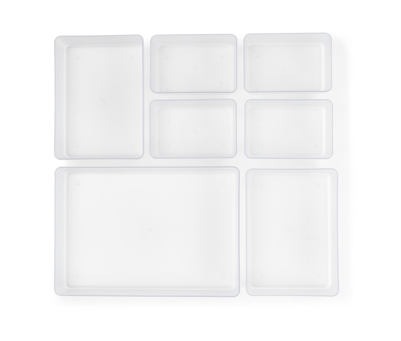 Widok z góry na zestaw przezroczystych organizerów do szuflad.