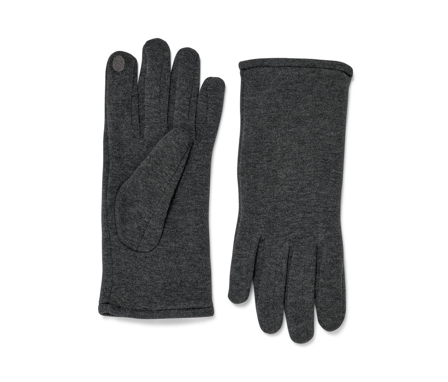 Dwie rękawiczki dresowe leżą obok siebie.