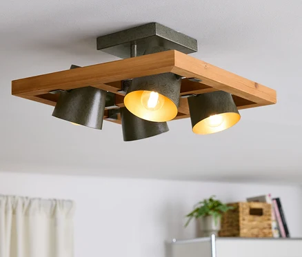 Lampa sufitowa z drewnianą ramą i czterema szarymi reflektorami.