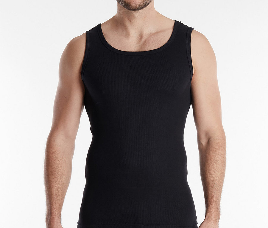 Mężczyzna o kręconych włosach w czarnym podkoszulku i bokserkach na białym tle.