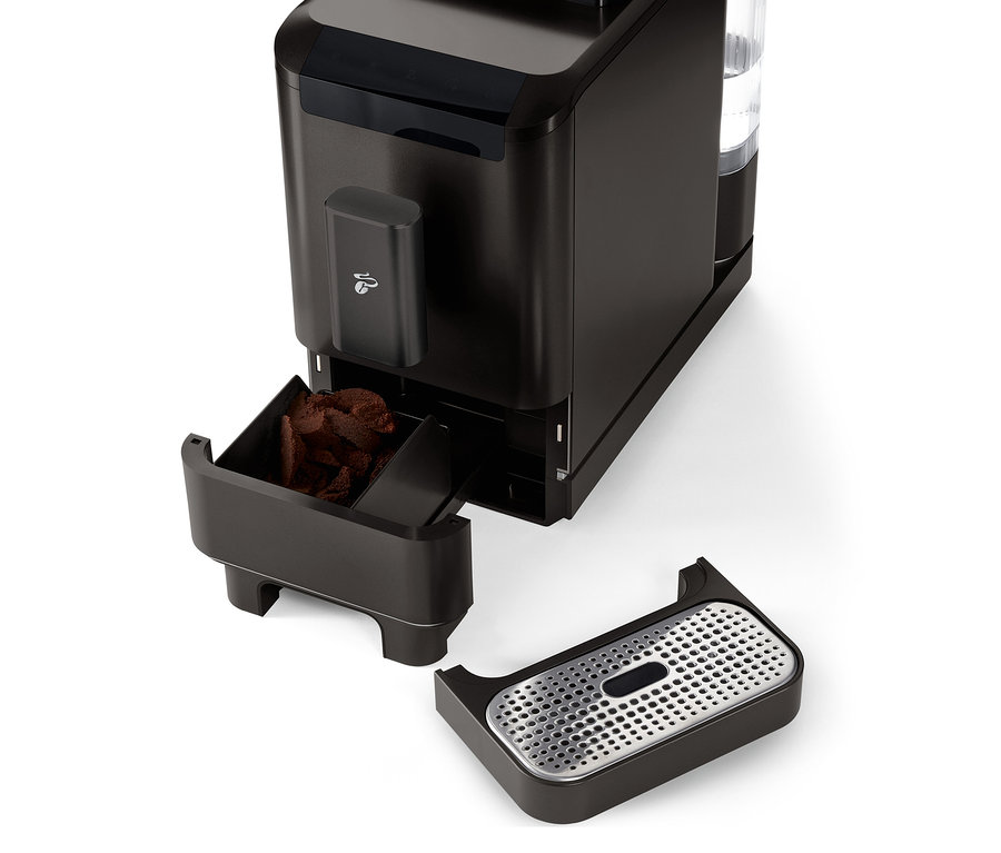 Szczegółowy widok automatycznego ekspresu do kawy »Esperto2 Caffè« w kolorze granite black z wysuniętym pojemnikiem na fusy i tacką ociekową.