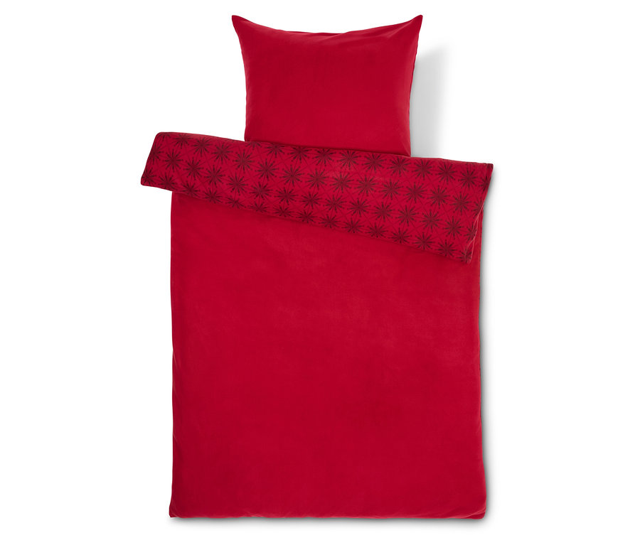 Czerwona pościel w gwiazdy z poduszką.