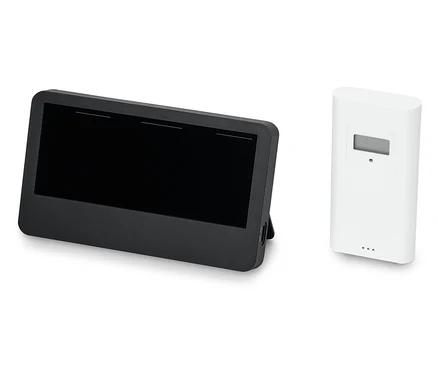 Czarny tablet obok białego czujnika.