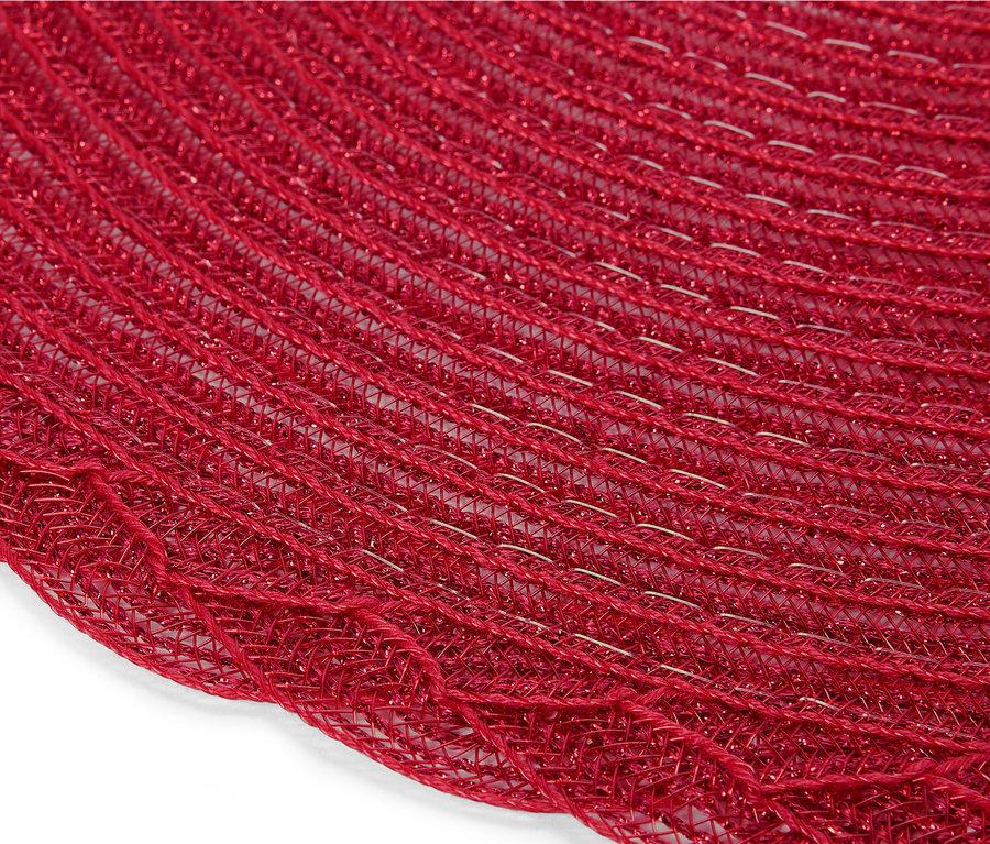Zbliżenie na okrągłą, czerwoną podkładkę stołową z plecionej siatki.