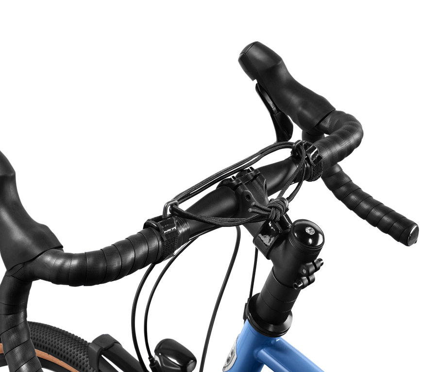 Zbliżenie na niebieski rower z czarną kierownicą i taśmą elastyczną na kierownicę.