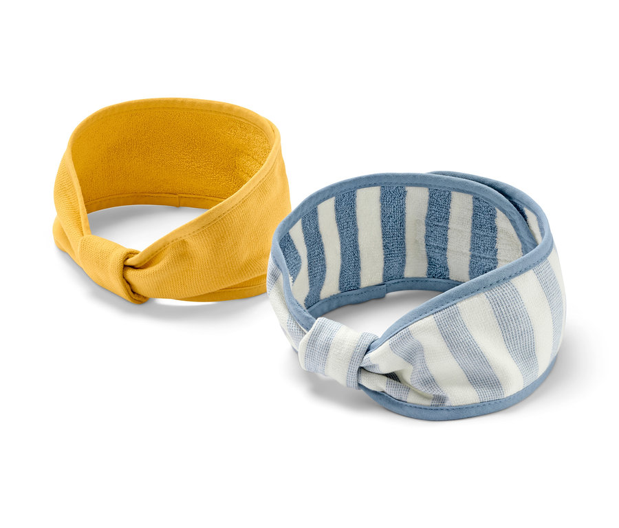 Dwie opaski kosmetyczne: żółta i biało-niebieska w paski.