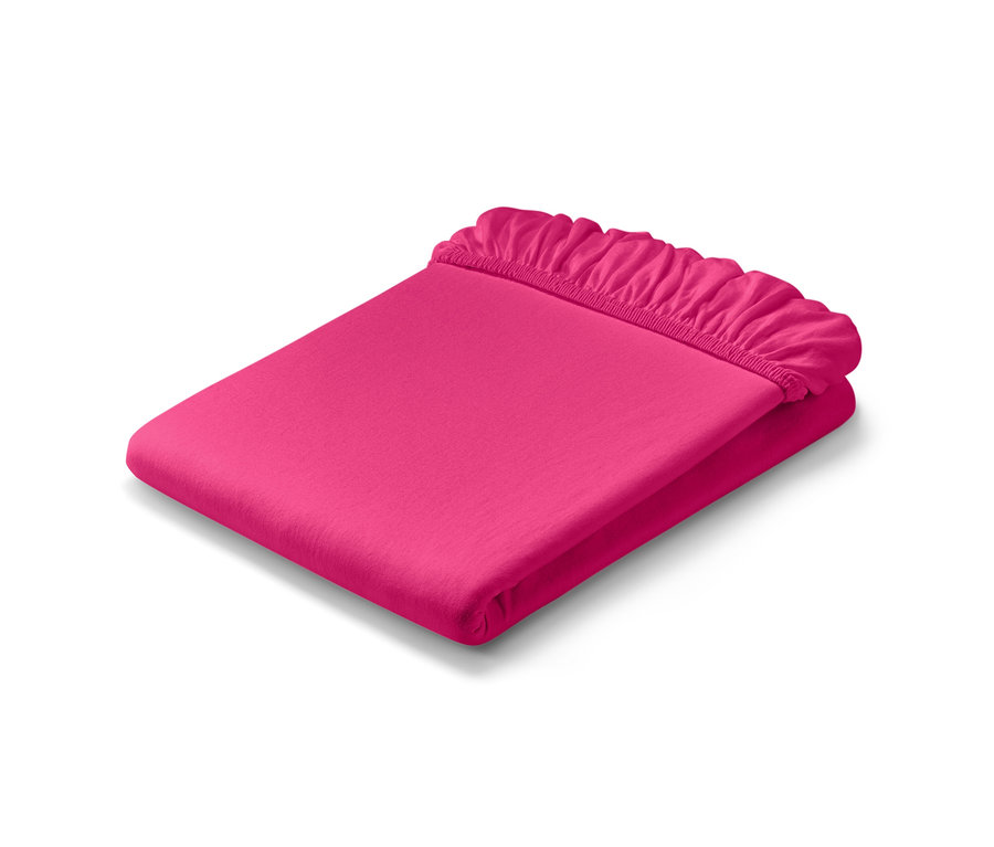 Złożone różowe prześcieradło dżersejowe z gumką w rozmiarze standardowym i prześcieradło dżersejowe z gumką w rozmiarze podwójnym.