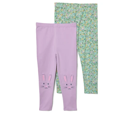 Dwa legginsy. Jedne fioletowe z uszami królika i twarzą na kolanach, a drugie zielone w kwiatowy wzór.