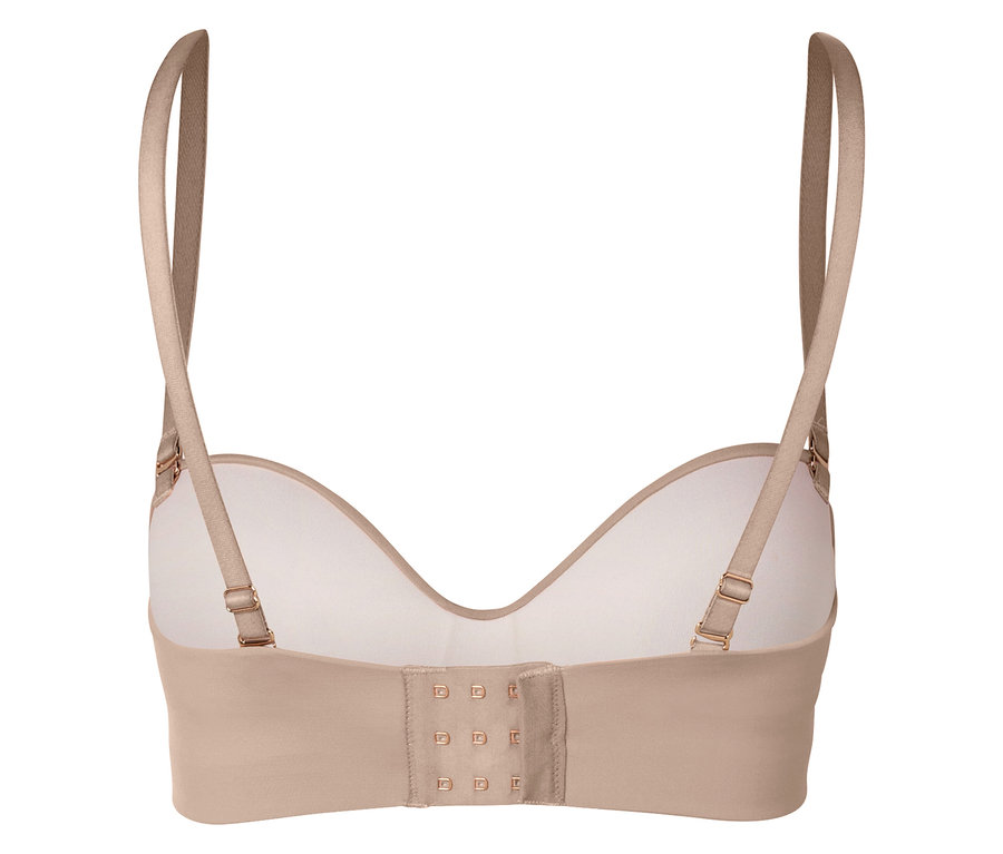Zbliżenie na tył beżowego biustonosza z regulowanymi ramiączkami i zapięciem na haftki.