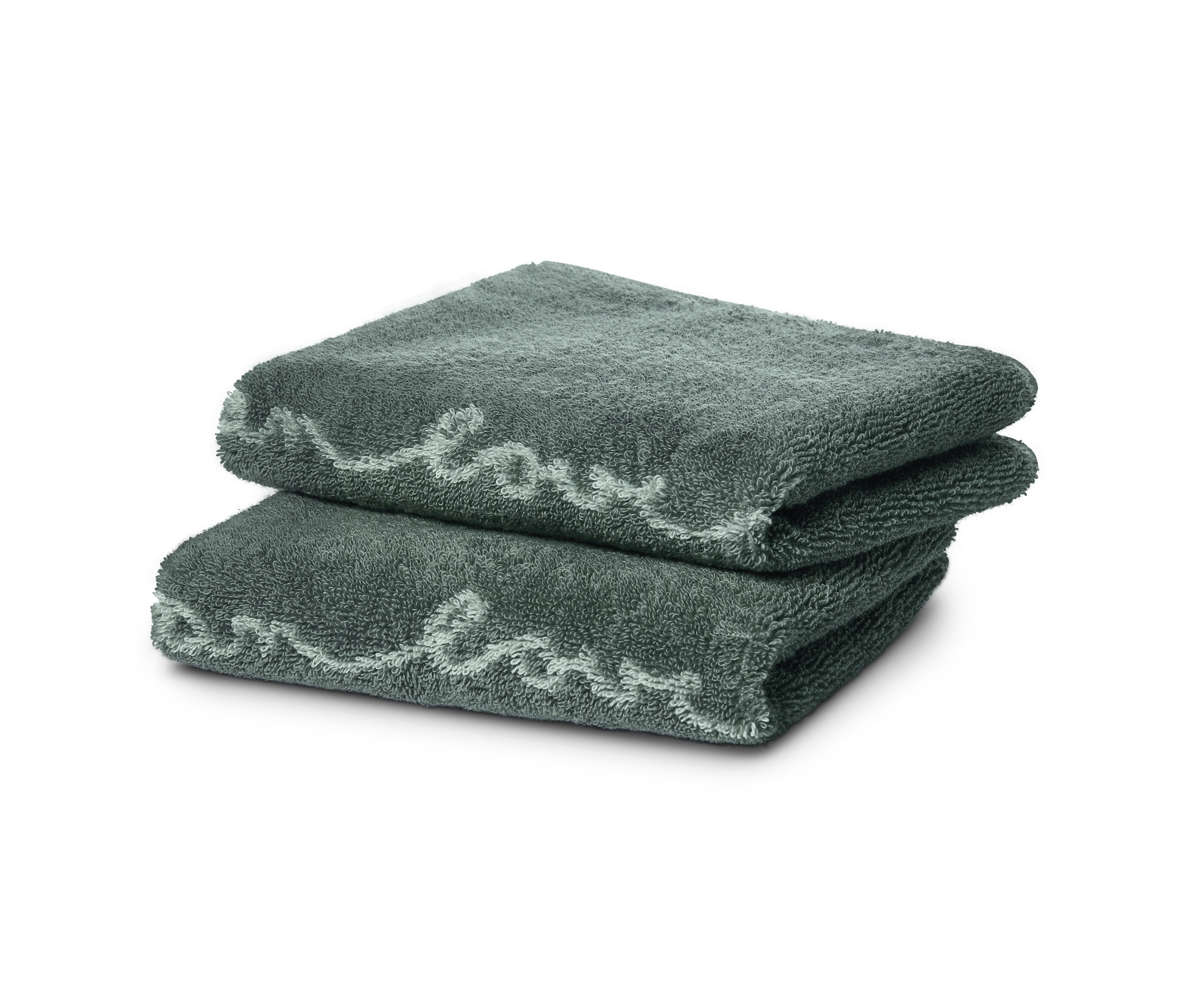 Dwa żakardowe ręczniki dla gości złożone na sobie.