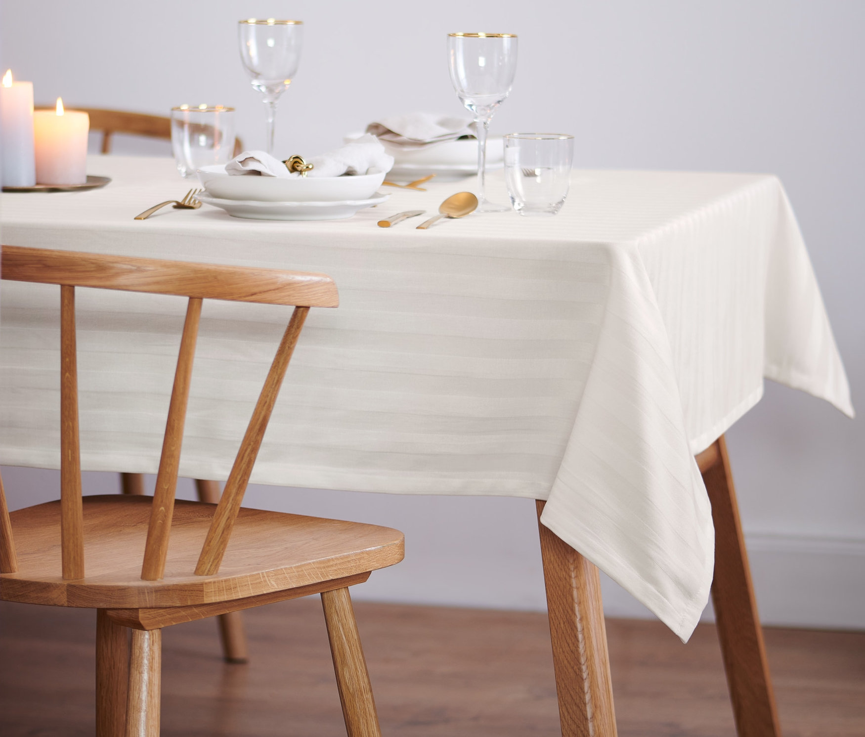 Nakryty stół z obrusem żakardowym.