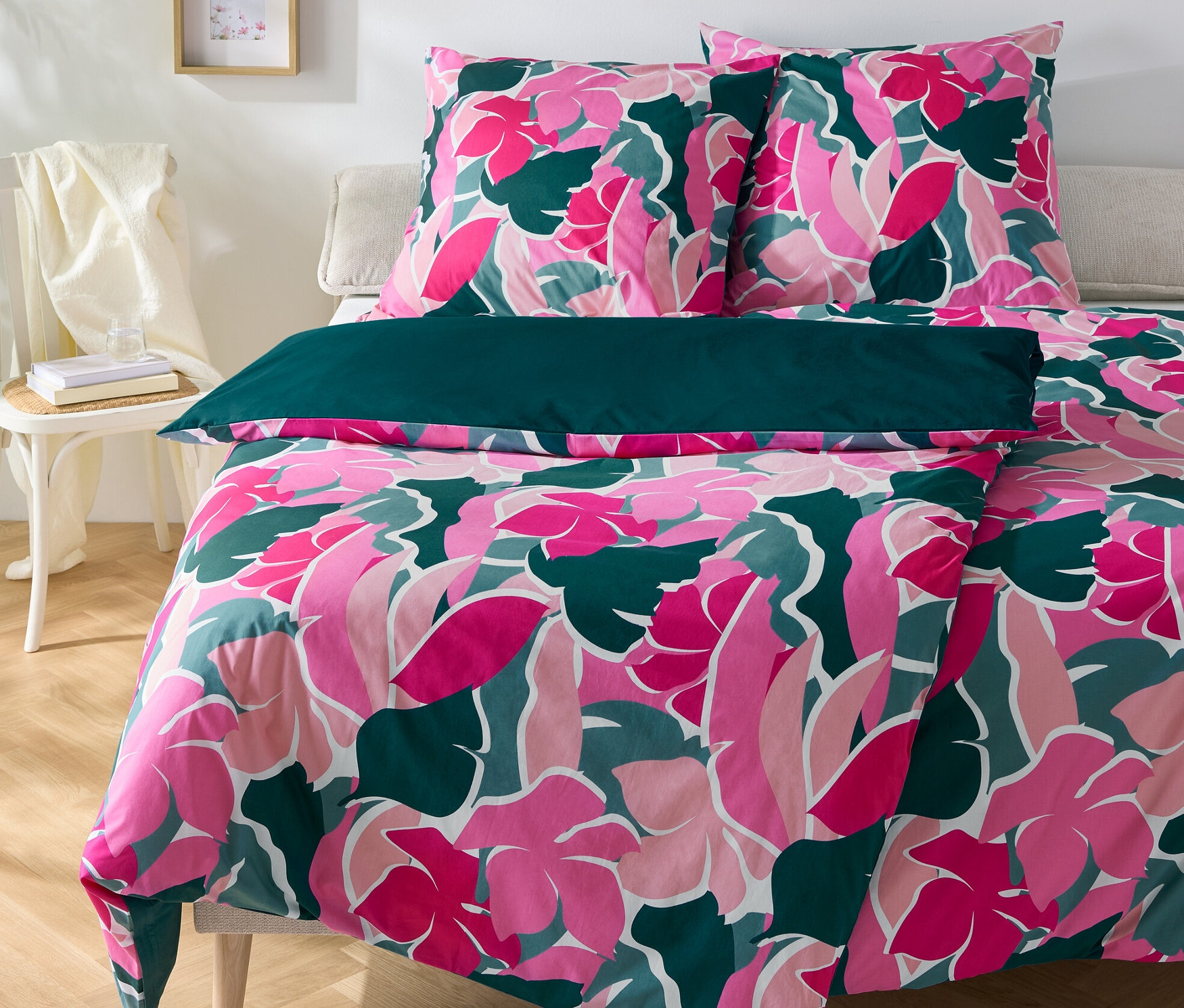 Kwiatowa pościel perkalowa, dwa rozmiary standardowe i jeden niestandardowy, leżą na łóżku.