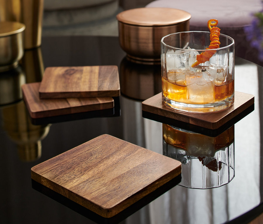 Szklanka z napojem stoi na jednej z 4 podstawek.