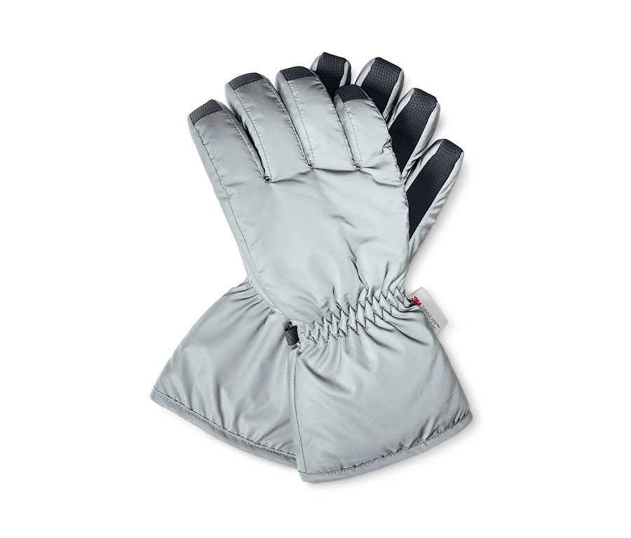 Dwie odblaskowe rękawice zimowe leżą na sobie.