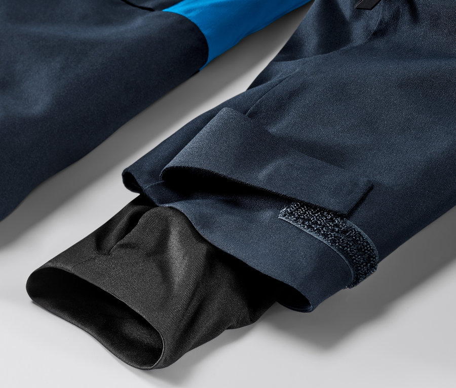 Detal niebieskiej kurtki narciarskiej.