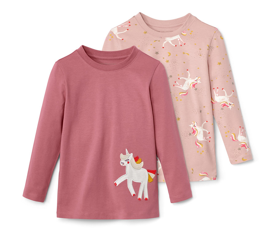 Dwie koszulki z długim rękawem z motywem jednorożca. Jedna koszulka jest różowa z nadrukiem jednorożców i gwiazdek, druga jest fioletowa z naszywką jednorożca.