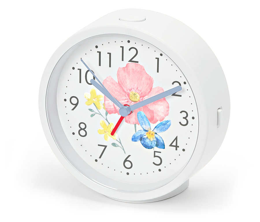 Budzik z podświetleniem, tarcza z motywem kwiatowym.