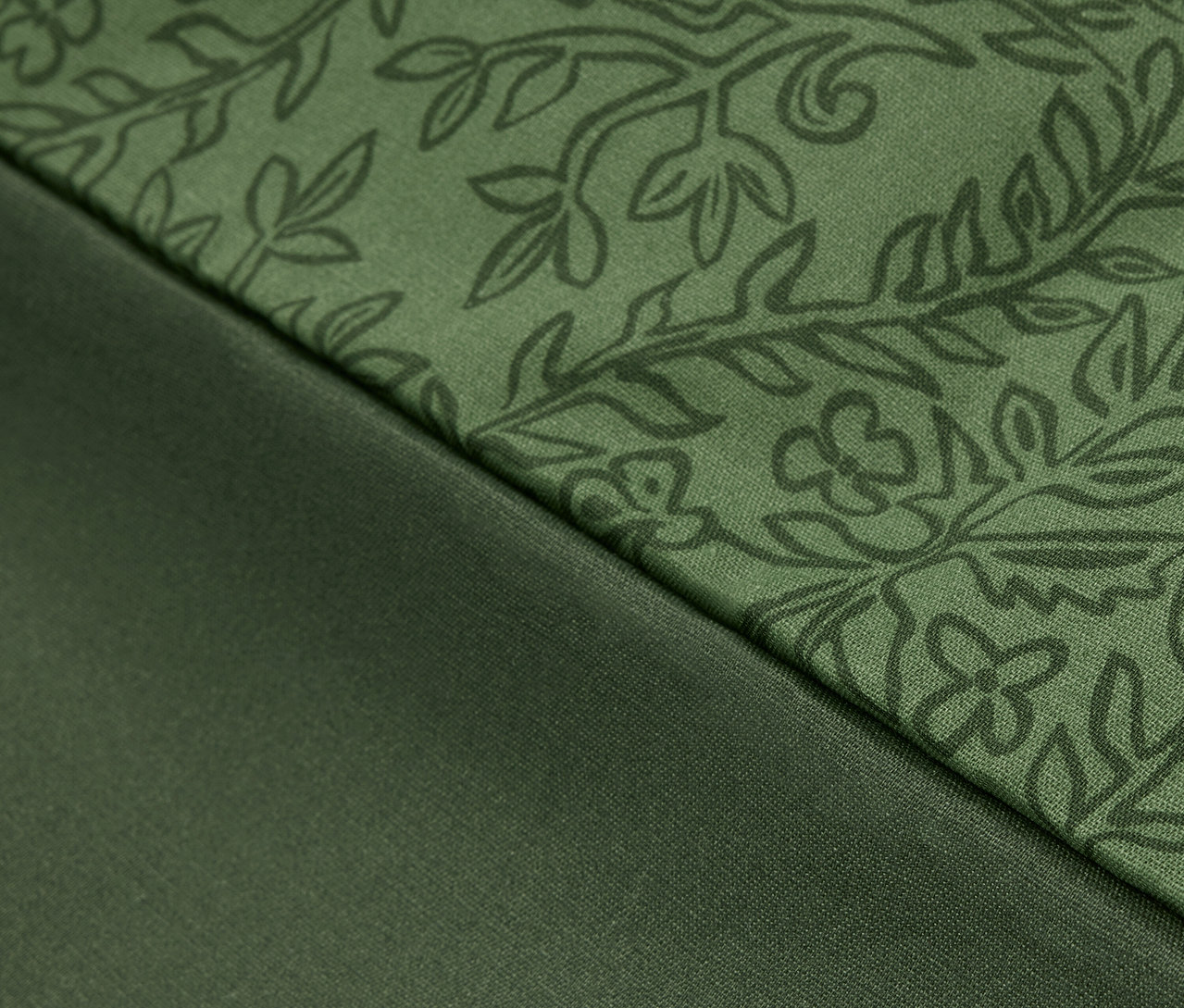 Zbliżenie zielonej tkaniny we wzory kwiatowe i gładkiej zielonej tkaniny.
