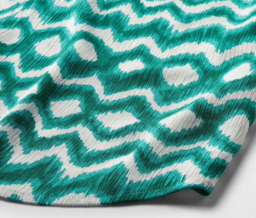 Fragment tuniki z nadrukiem.