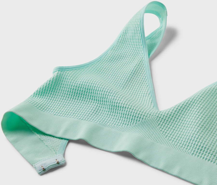 Szczegółowy widok jasnoturkusowego bezszwowego biustonosza z fakturą.