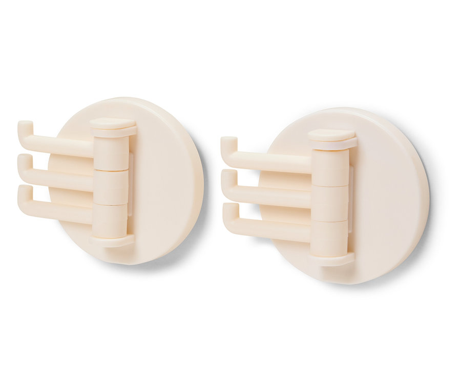 Dwa kremowe, obrotowe haczyki na białym tle.